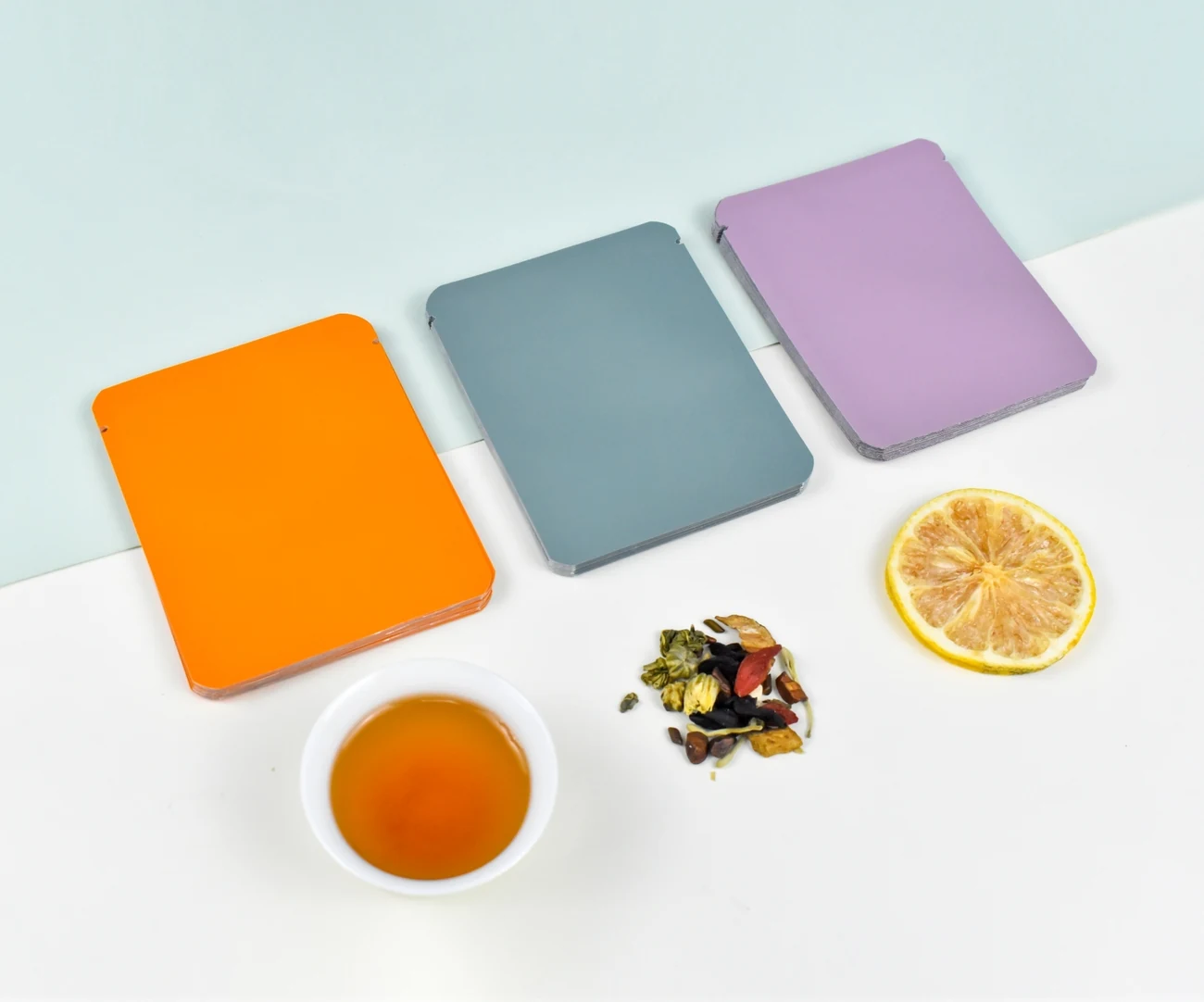 Colorful flat tea sachets with tea and dried fruit